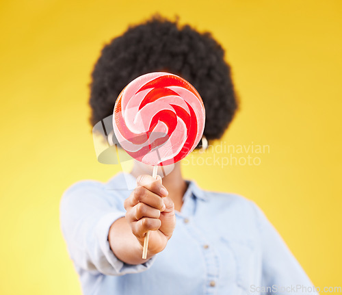 Image of Cover, candy and lollipop with black woman in studio for colorful, cheerful and positive. Young, sweets and dessert with female isolated on yellow background for treats, food and confectionary