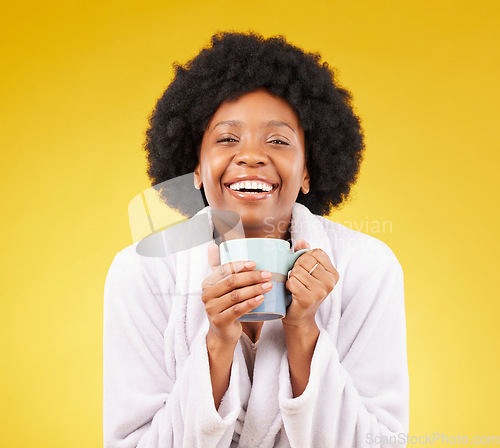 Image of Bathrobe, coffee and portrait of happy black woman in studio, waking up in the morning and smile on yellow background. Face, relax and isolated female with tea, satisfied with stress relief