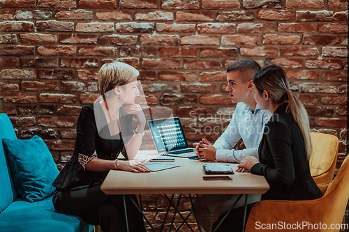 Image of Happy businesspeople smiling cheerfully during a meeting in a coffee shop. Group of successful business professionals working as a team in a multicultural workplace.