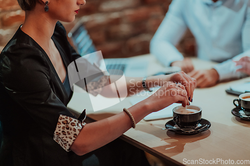 Image of Happy businesspeople smiling cheerfully during a meeting in a coffee shop. Group of successful business professionals working as a team in a multicultural workplace.