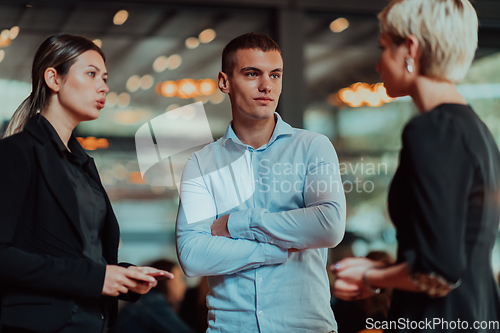 Image of Photo of a business team of young people discussing business ideas in a modern urban environment. Selective focus