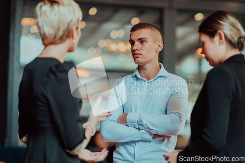 Image of Photo of a business team of young people discussing business ideas in a modern urban environment. Selective focus