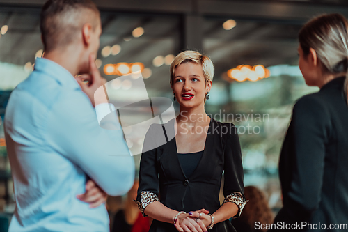 Image of Photo of a business team of young people discussing business ideas in a modern urban environment. Selective focus