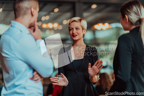 Image of Photo of a business team of young people discussing business ideas in a modern urban environment. Selective focus