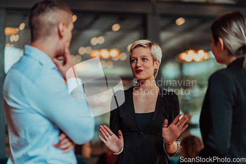 Image of Photo of a business team of young people discussing business ideas in a modern urban environment. Selective focus