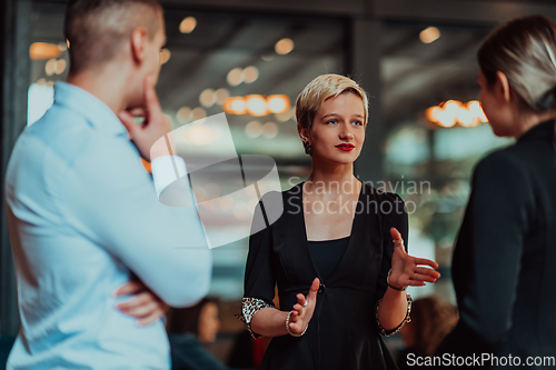 Image of Photo of a business team of young people discussing business ideas in a modern urban environment. Selective focus