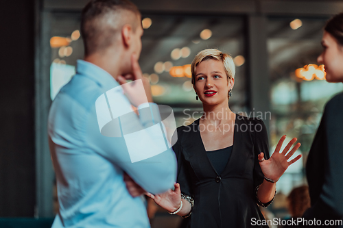 Image of Photo of a business team of young people discussing business ideas in a modern urban environment. Selective focus