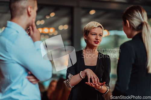 Image of Photo of a business team of young people discussing business ideas in a modern urban environment. Selective focus