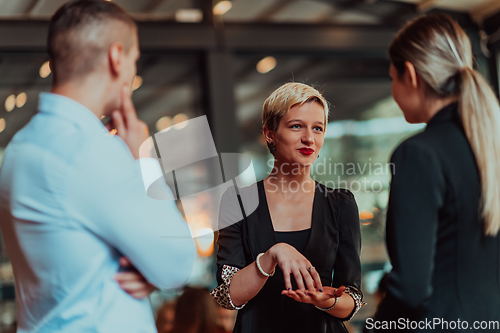 Image of Photo of a business team of young people discussing business ideas in a modern urban environment. Selective focus