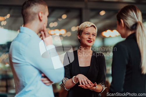 Image of Photo of a business team of young people discussing business ideas in a modern urban environment. Selective focus