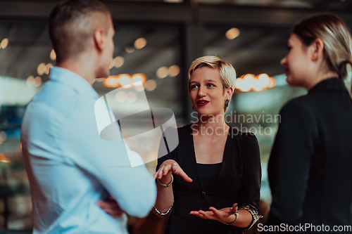 Image of Photo of a business team of young people discussing business ideas in a modern urban environment. Selective focus