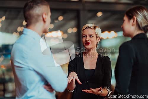 Image of Photo of a business team of young people discussing business ideas in a modern urban environment. Selective focus