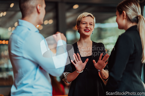 Image of Photo of a business team of young people discussing business ideas in a modern urban environment. Selective focus