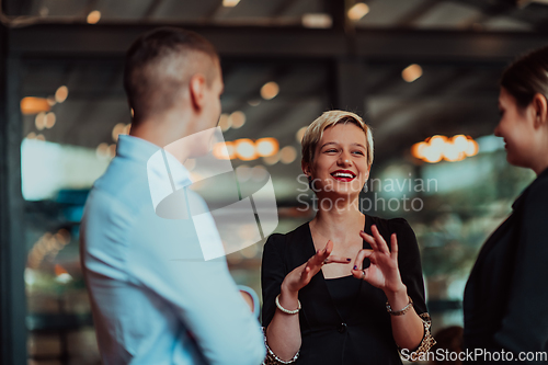 Image of Photo of a business team of young people discussing business ideas in a modern urban environment. Selective focus