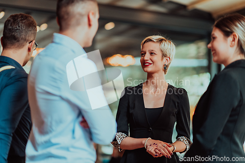 Image of Photo of a business team of young people discussing business ideas in a modern urban environment. Selective focus