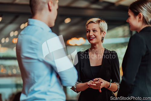 Image of Photo of a business team of young people discussing business ideas in a modern urban environment. Selective focus