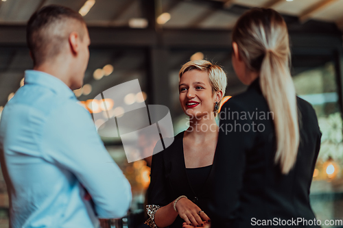 Image of Photo of a business team of young people discussing business ideas in a modern urban environment. Selective focus