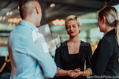 Image of Photo of a business team of young people discussing business ideas in a modern urban environment. Selective focus