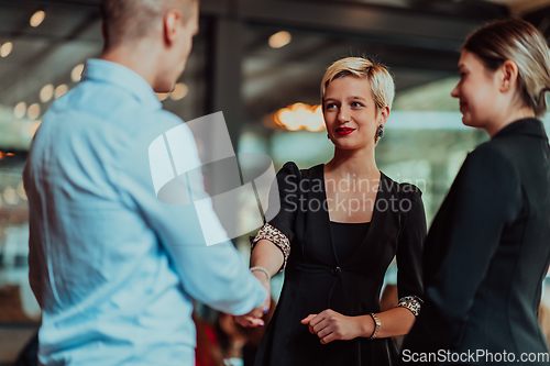 Image of Photo of a business team of young people discussing business ideas in a modern urban environment. Selective focus