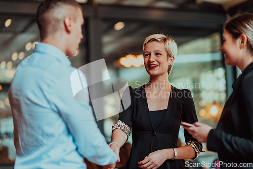 Image of Photo of a business team of young people discussing business ideas in a modern urban environment. Selective focus