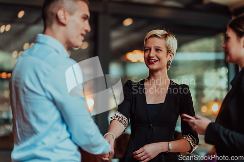 Image of Photo of a business team of young people discussing business ideas in a modern urban environment. Selective focus