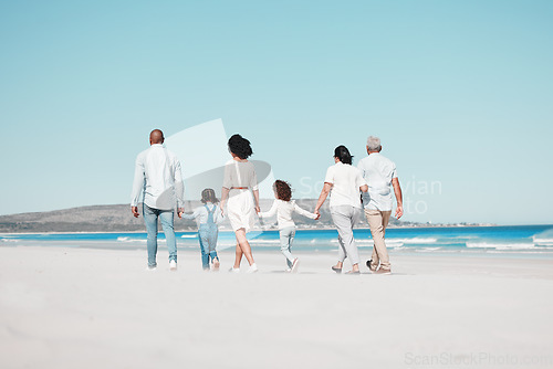 Image of Grandparents, parents and children on beach walking to relax on summer holiday, vacation and weekend. Blue sky, travel and back of big family holding hands for bonding, quality time and calm by ocean