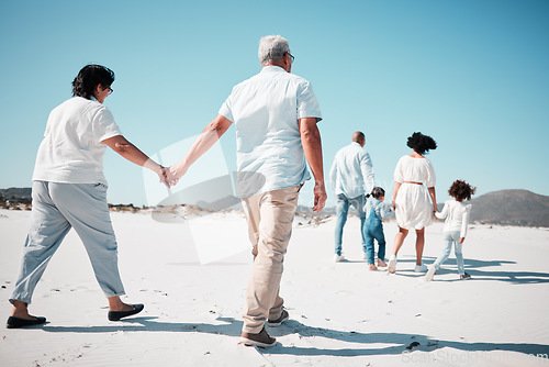 Image of Elderly couple, holding hands and family at beach with back for walk, freedom and vacation together with love. Old man, woman and grandchildren by ocean for walking, wellness and journey in sunshine