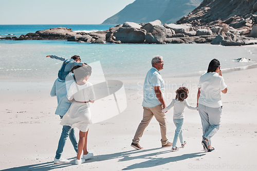 Image of Grandparents, parents and children on beach walking to relax on summer holiday, vacation and weekend. Nature, travel and back of big family holding hands for bonding, quality time and calm by ocean