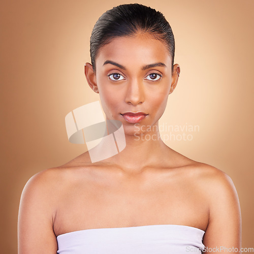 Image of Skincare, beauty and portrait of Indian woman for wellness, healthy skin and facial treatment in studio. Dermatology, luxury spa mockup and serious face of girl with makeup, cosmetics and confidence