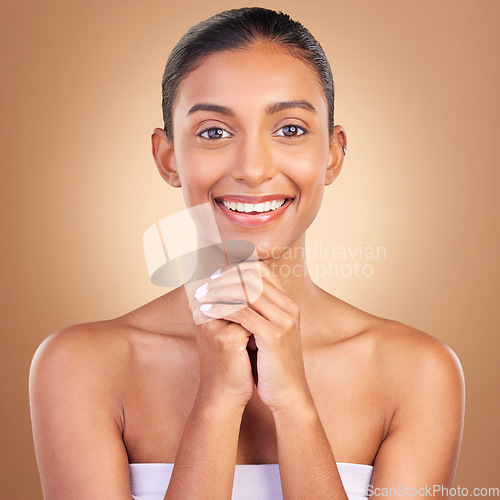 Image of Beauty, skincare and portrait with indian woman in studio for happy, spa detox and facial. Cosmetics, self care and glow with model on brown background for satisfaction, natural makeup or confidence