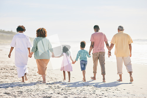 Image of Family at beach, holding hands and generations walk on sand, people outdoor with grandparents, parents and kids. Together, support and trust, travel to Bali with love, care and bond with back view