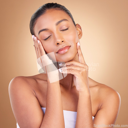 Image of Beauty, skincare and relax with indian woman in studio for touch, spa treatment and facial. Cosmetics, self care and glow with model on brown background for satisfaction, empowerment and confidence