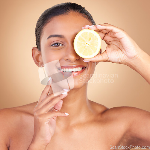 Image of Skincare, woman portrait and lemon glow for health, wellness and beauty of a young model with happiness. Studio, smile and healthy fruit with vitamin c and fruits nutrition for facial and dermatology