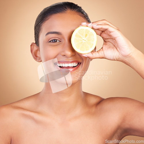 Image of Skincare, lemon and portrait of a woman with health, wellness and beauty of a young happy model. Studio, smile and healthy fruit with vitamin c and diet nutrition for facial and spa dermatology