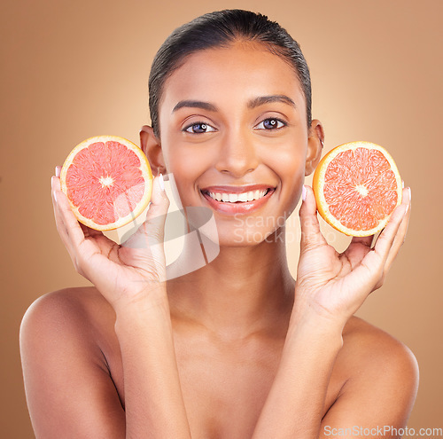 Image of Skincare, woman smile portrait and grapefruit for health, wellness and beauty of a young model with happiness. Studio, detox and healthy fruit with vitamin c and nutrition for facial and dermatology