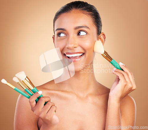 Image of Makeup brushes, happy and woman with natural beauty, wellness and face shine from cosmetics. Facial skin glow, smile and cosmetic artist brush of a young female model with self care in a studio