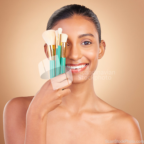 Image of Makeup brush, smile portrait and woman with natural beauty, wellness and happiness from cosmetics. Facial skin glow, happy and cosmetic artist tool of a young female model with self care in a studio