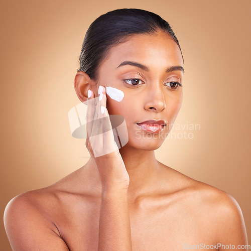 Image of Skincare, sunscreen and natural beauty of a woman with cosmetic and spa cream. Isolated, studio background and young model with a glow from face cleaning, cosmetics and dermatology facial product