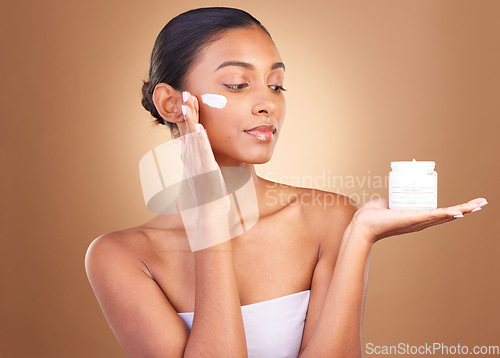 Image of Skincare product, sunscreen and wellness of a relax woman with cosmetic and spa cream. Isolated, studio background and young model with beauty from face cleaning, cosmetics and dermatology facial