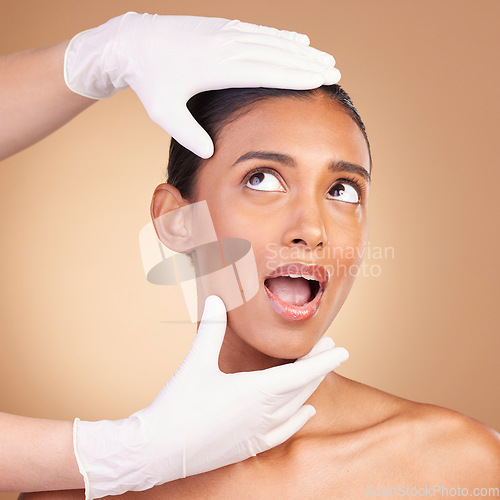 Image of Woman, face and hands in plastic surgery for cosmetics, skincare or beauty against a studio background. Hand of surgeon or beautician with female in spa or facial treatment for medical procedure