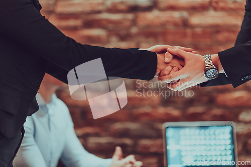 Image of Business shaking hands, finishing up meeting. Successful businesspeople handshaking after good deal