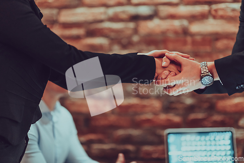 Image of Business shaking hands, finishing up meeting. Successful businesspeople handshaking after good deal