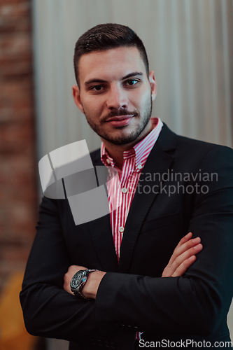 Image of Portrait of a young businessman in a modern suit. Portrait of the company director in his office. Selective focus