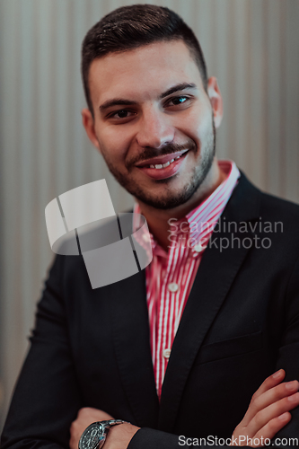 Image of Portrait of a young businessman in a modern suit. Portrait of the company director in his office. Selective focus