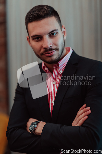 Image of Portrait of a young businessman in a modern suit. Portrait of the company director in his office. Selective focus