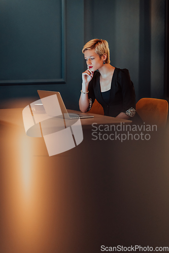 Image of Businesswoman sitting in a cafe while focused on working on a laptop and participating in an online meetings. Selective focus.