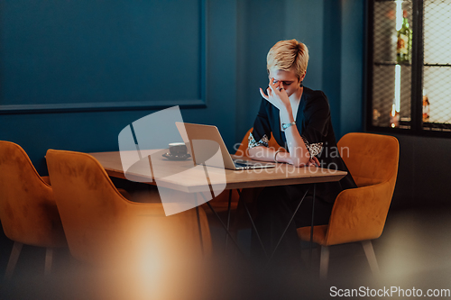 Image of Businesswomen are stressed while working on laptop, Tired businesswoman with headache in coffee shop , feeling sick at work. Selective focus