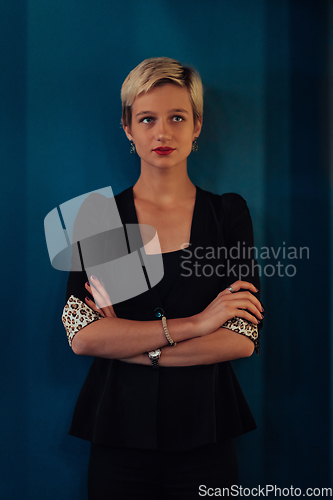 Image of Blonde business woman, successful confidence with arms crossed on modern blue mat background. Selective focus