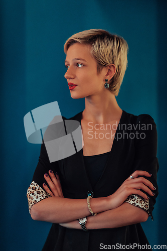 Image of Blonde business woman, successful confidence with arms crossed on modern blue mat background. Selective focus
