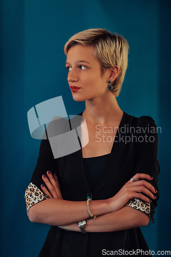 Image of Blonde business woman, successful confidence with arms crossed on modern blue mat background. Selective focus